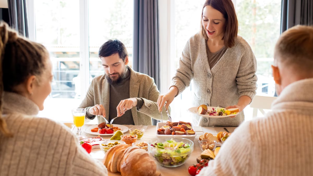 Warm indoor gathering with family enjoying a meal together, showcasing joy and togetherness.